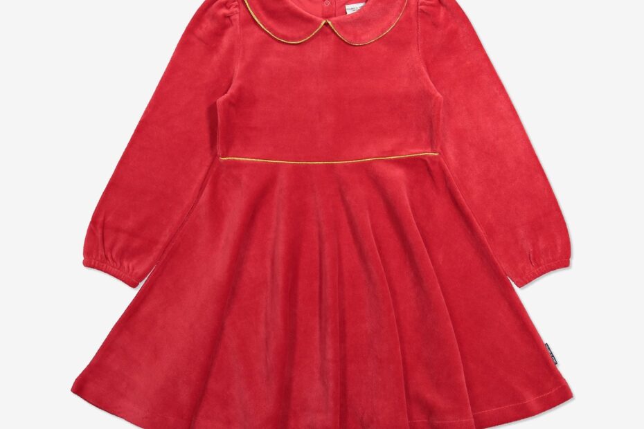 red velour dress with gold trim laid flat on white background